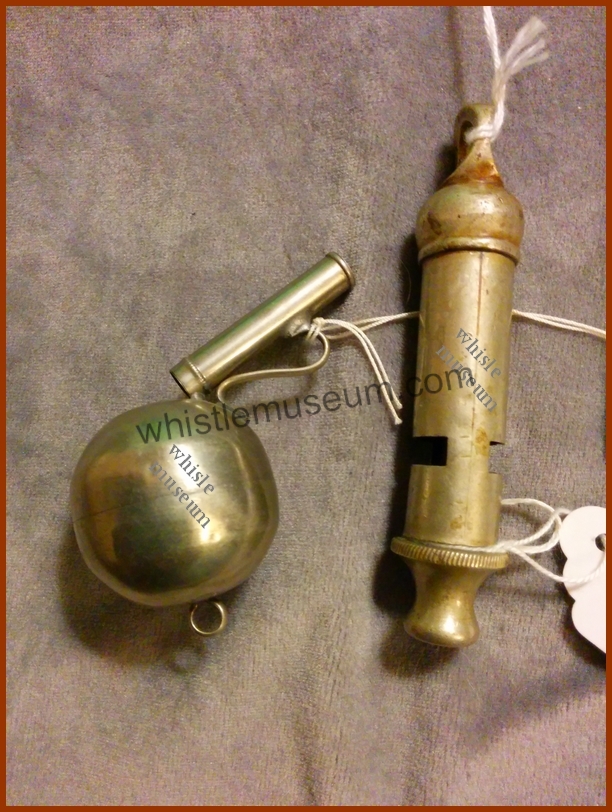 Large Spherical whistle, Globular short buson type whistle beside a large Bobby whistle for size comparison whistle museum